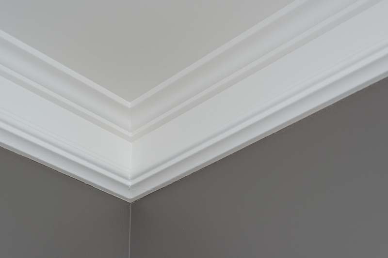 Details in the interior close-up. Ceiling moldings, part of intricate corner.